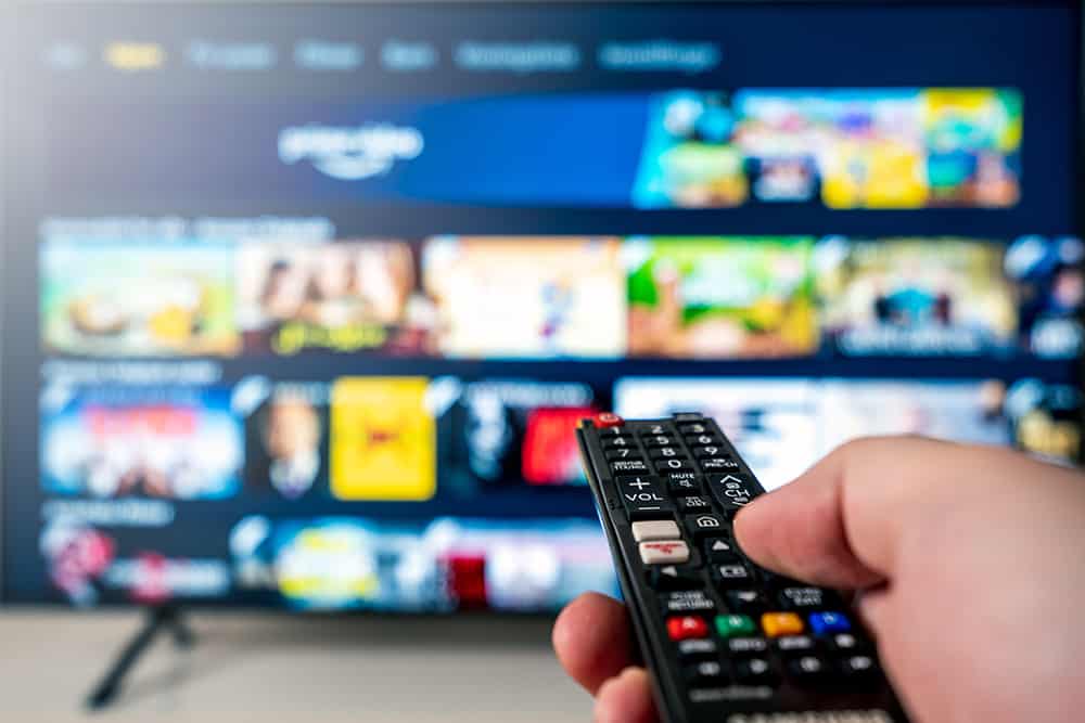 image of someone holding a tv remote pointing it at a TV (TV Commercials)